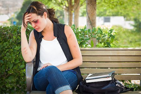 Sad Bruised and Battered Young Woman Sitting on Bench Outside at a Park. Photographie de stock - Aubaine LD & Abonnement, Code: 400-08253491