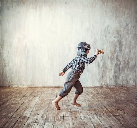 Running boy with plane indoors Stock Photo - Budget Royalty-Free & Subscription, Code: 400-08253687