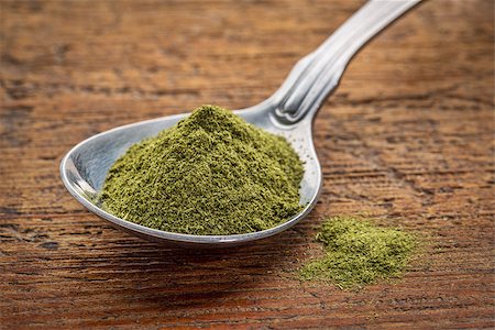 simsearch:400-08339036,k - green freeze-dried organic wheat grass powder, nutritional supplement on a tablespoon against rustic wood Stock Photo - Budget Royalty-Free & Subscription, Code: 400-08253691
