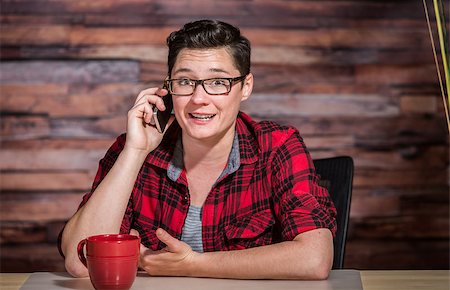 Happy lesbian corporate worker in casual shirt on phone Stock Photo - Budget Royalty-Free & Subscription, Code: 400-08253702