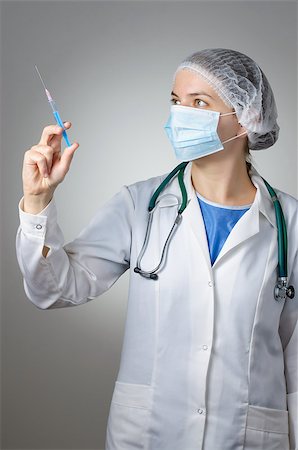 Female doctor with syringe and face mask Stock Photo - Budget Royalty-Free & Subscription, Code: 400-08253775