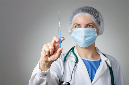 Female doctor with syringe and face mask Stock Photo - Budget Royalty-Free & Subscription, Code: 400-08253806