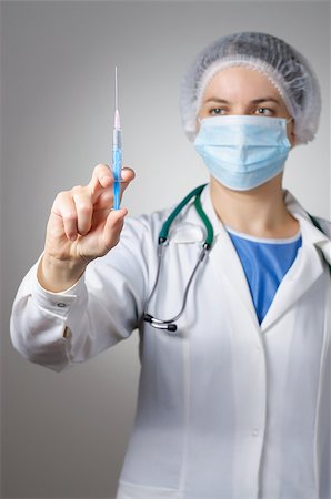 Female doctor with syringe and face mask Stock Photo - Budget Royalty-Free & Subscription, Code: 400-08253881