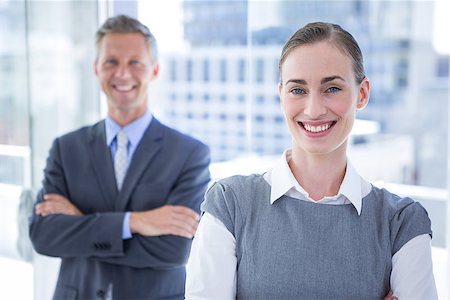 simsearch:400-06879262,k - Businesswoman smiling at the camera while her colleague smiling in the background Stock Photo - Budget Royalty-Free & Subscription, Code: 400-08264498