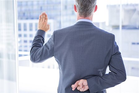 simsearch:400-06879262,k - Businessman making a oath while crossing fingers behind his back Stock Photo - Budget Royalty-Free & Subscription, Code: 400-08264490