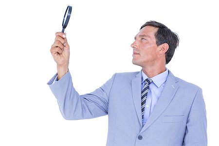 simsearch:400-06879262,k - concentrated businessman using magnifying glass on white background Stock Photo - Budget Royalty-Free & Subscription, Code: 400-08264637