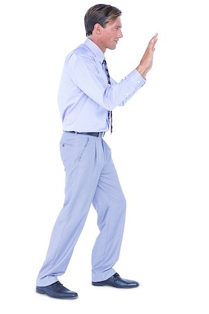 simsearch:400-06879262,k - Businessman walking while gesturing with hands on a white background Stock Photo - Budget Royalty-Free & Subscription, Code: 400-08264643