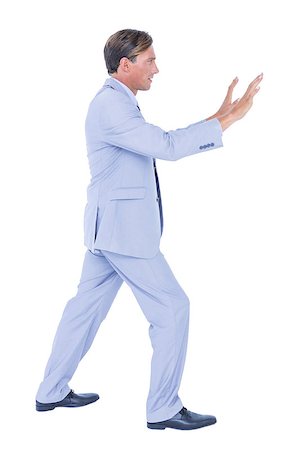 simsearch:400-06879262,k - Businessman walking while gesturing with hands on a white background Stock Photo - Budget Royalty-Free & Subscription, Code: 400-08264665