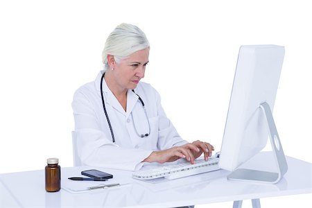 simsearch:695-05771285,k - Doctor working on her computer on a white screen Foto de stock - Royalty-Free Super Valor e Assinatura, Número: 400-08264714