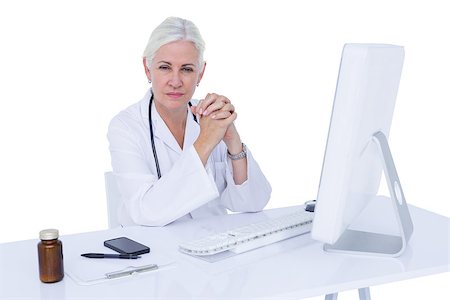 simsearch:695-05771285,k - Doctor working on her computer on a white screen Foto de stock - Royalty-Free Super Valor e Assinatura, Número: 400-08264715
