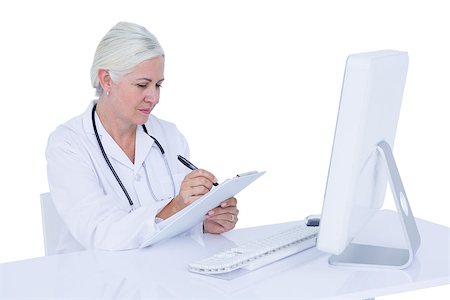 simsearch:695-05771285,k - Doctor working on her computer on a white screen Foto de stock - Royalty-Free Super Valor e Assinatura, Número: 400-08264719
