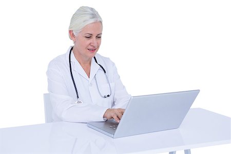 simsearch:695-05771285,k - Doctor working on her laptop and calling on a white scree Foto de stock - Royalty-Free Super Valor e Assinatura, Número: 400-08264710