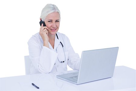 simsearch:6109-06006905,k - Doctor working on her laptop and calling on a white screen Stock Photo - Budget Royalty-Free & Subscription, Code: 400-08264724