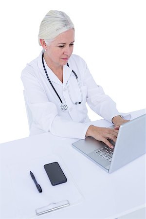 simsearch:6109-06006905,k - Doctor working on her laptop and calling on a white screen Stock Photo - Budget Royalty-Free & Subscription, Code: 400-08264723
