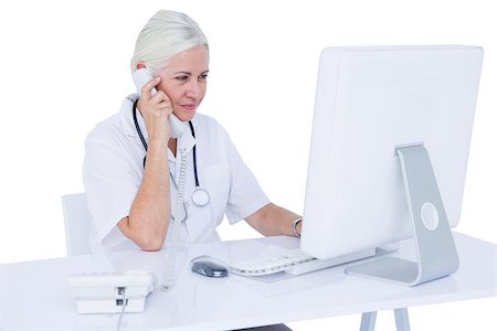 simsearch:6109-06006905,k - Doctor working on her laptop and calling on a white screen Stock Photo - Budget Royalty-Free & Subscription, Code: 400-08264734