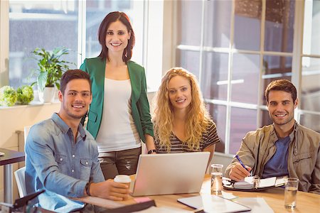 simsearch:400-07553777,k - Group of young colleagues using laptop at office Stock Photo - Budget Royalty-Free & Subscription, Code: 400-08264941