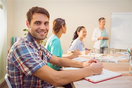 A young designer listening to a conference in the office Stock Photo - Budget Royalty-Free & Subscription, Code: 400-08265036