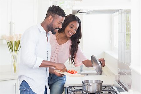 Happy couple cooking food together at home in the kitchen Stock Photo - Budget Royalty-Free & Subscription, Code: 400-08265491