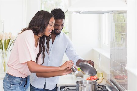 Happy couple cooking food together at home in the kitchen Stock Photo - Budget Royalty-Free & Subscription, Code: 400-08265492