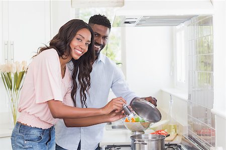 Happy couple cooking food together at home in the kitchen Stock Photo - Budget Royalty-Free & Subscription, Code: 400-08265493