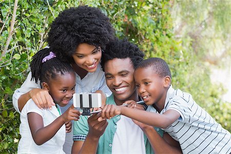 Happy family taking a selfie in the garden at home Stock Photo - Budget Royalty-Free & Subscription, Code: 400-08265566