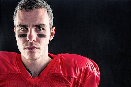 simsearch:6109-08389992,k - Portrait of a serious american football player looking at camera with black background Stock Photo - Budget Royalty-Free & Subscription, Code: 400-08265654