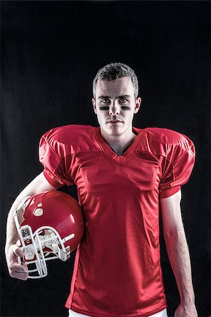 simsearch:625-02931241,k - A serious american football player looking at camera with black background Fotografie stock - Microstock e Abbonamento, Codice: 400-08265651