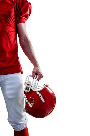 quarterback - A serious american football player taking his helmet on her hand looking at camera with white background Fotografie stock - Microstock e Abbonamento, Codice: 400-08265671