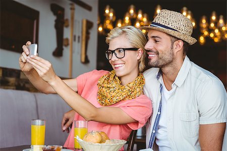 Hipster couple taking a selfie in a cafe Stock Photo - Budget Royalty-Free & Subscription, Code: 400-08265740