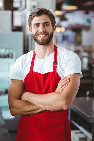 simsearch:632-08331381,k - Handsome barista smiling at the camera at the cafe Foto de stock - Super Valor sin royalties y Suscripción, Código: 400-08265804