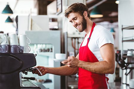 Handsome barista preparing a cup of coffee with the coffee machine Stock Photo - Budget Royalty-Free & Subscription, Code: 400-08265807