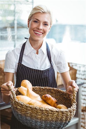 Pretty waitress carrying basket of bread at the baker Stock Photo - Budget Royalty-Free & Subscription, Code: 400-08265854