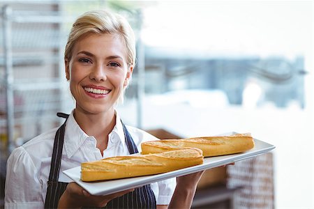 Pretty waitress carrying baguettes at the bakery Stock Photo - Budget Royalty-Free & Subscription, Code: 400-08265853
