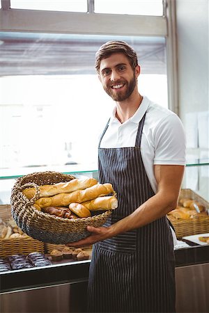 simsearch:400-08265905,k - Portrait of happy worker holding basket of bread at the bakery Foto de stock - Super Valor sin royalties y Suscripción, Código: 400-08265896