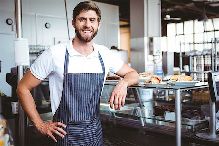 Handsome worker posing on the counter at the bakery Stock Photo - Budget Royalty-Free & Subscription, Code: 400-08265892