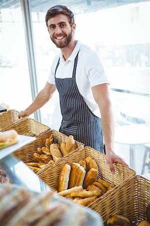 simsearch:400-08265905,k - Smiling worker posing behind the counter at the bakery Foto de stock - Super Valor sin royalties y Suscripción, Código: 400-08265909