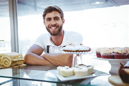 simsearch:400-08265905,k - Smiling worker posing behind the counter arm crossed at the bakery Foto de stock - Super Valor sin royalties y Suscripción, Código: 400-08265916