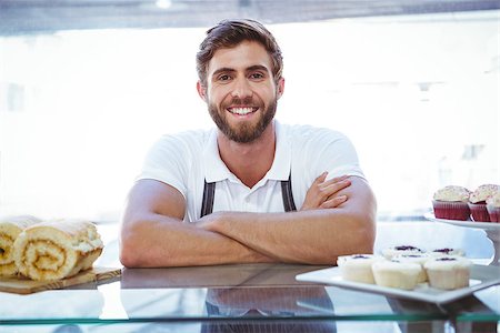 simsearch:400-08265905,k - Smiling worker posing behind the counter at the bakery Foto de stock - Super Valor sin royalties y Suscripción, Código: 400-08265913