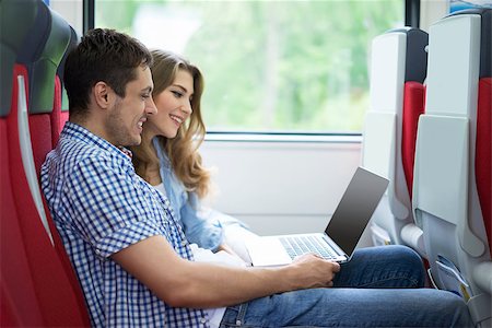 Young couple with a laptop in the train Stock Photo - Budget Royalty-Free & Subscription, Code: 400-08260222