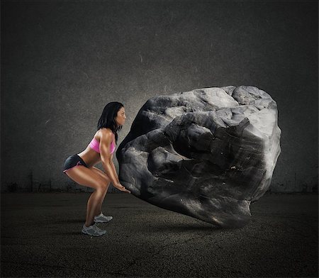Muscular woman lifts a big boulder heavy Stock Photo - Budget Royalty-Free & Subscription, Code: 400-08260338