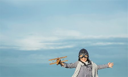 pilots with scarves - Happy boy with wooden airplane Stock Photo - Budget Royalty-Free & Subscription, Code: 400-08261155