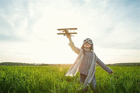 Little boy with wooden airplane in the field Stock Photo - Budget Royalty-Free & Subscription, Code: 400-08261157