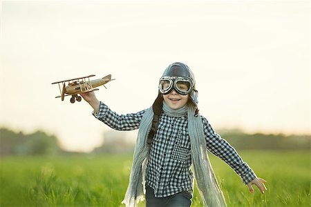 pilots with scarves - Little boy with wooden airplane in the field Stock Photo - Budget Royalty-Free & Subscription, Code: 400-08261159