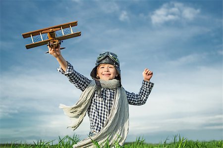 pilots with scarves - Happy boy with wooden airplane Stock Photo - Budget Royalty-Free & Subscription, Code: 400-08261150