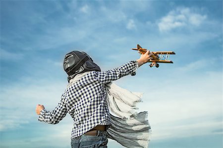 pilots with scarves - Little boy with wooden airplane Stock Photo - Budget Royalty-Free & Subscription, Code: 400-08261151