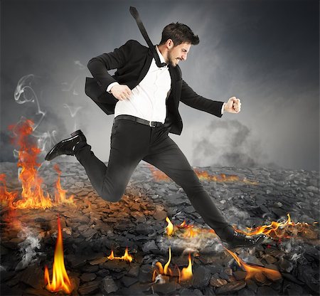 Determined businessman runs quickly on hot coals Photographie de stock - Aubaine LD & Abonnement, Code: 400-08261242