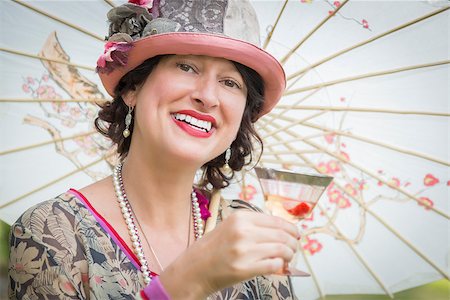 Beautiful 1920s Dressed Girl with Parasol and Glass of Wine Portrait. Stock Photo - Budget Royalty-Free & Subscription, Code: 400-08261902