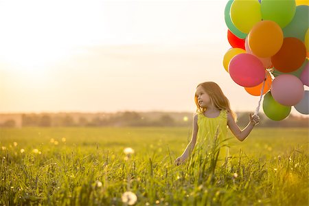 Little girl with balloons in the field Stock Photo - Budget Royalty-Free & Subscription, Code: 400-08262182