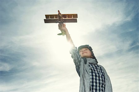 Boy with wooden airplane in the field Stock Photo - Budget Royalty-Free & Subscription, Code: 400-08262194