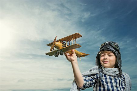 pilots with scarves - Boy with wooden airplane outdoors Stock Photo - Budget Royalty-Free & Subscription, Code: 400-08262197